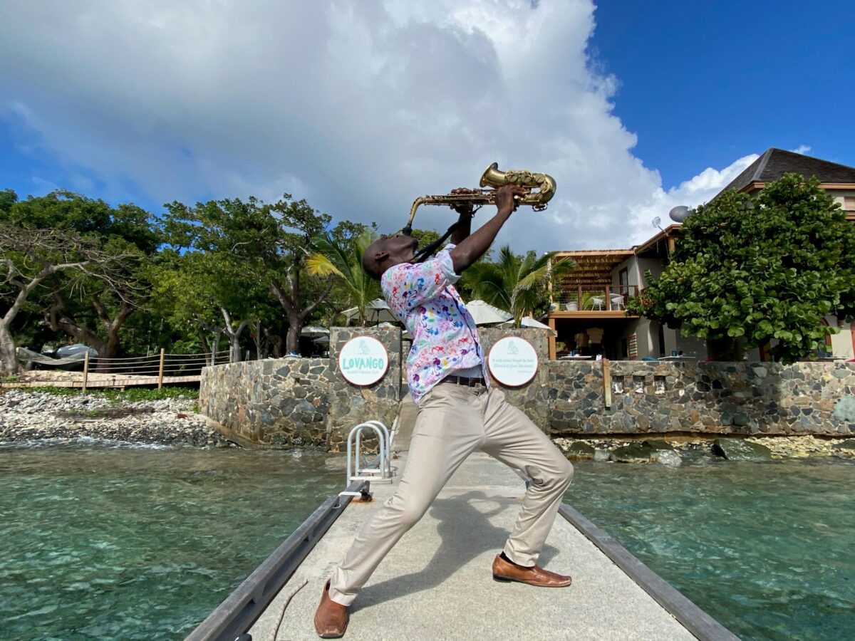 A man playing saxophone on the dock