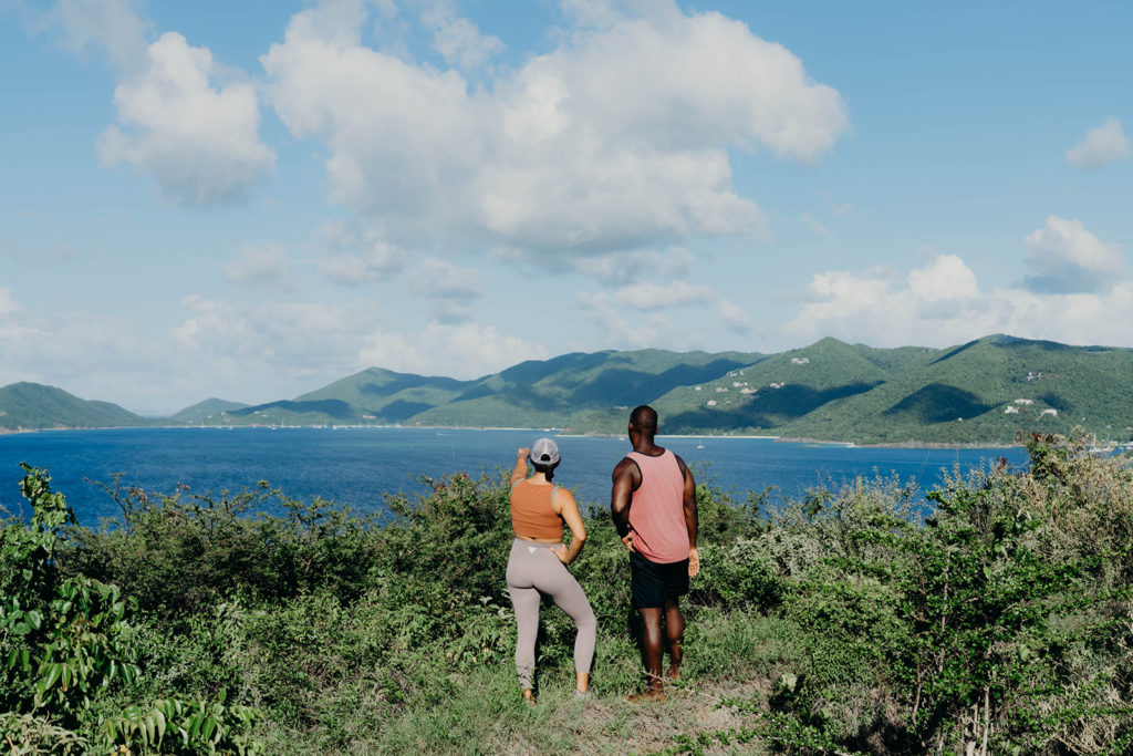 A man and woman looking out at the water