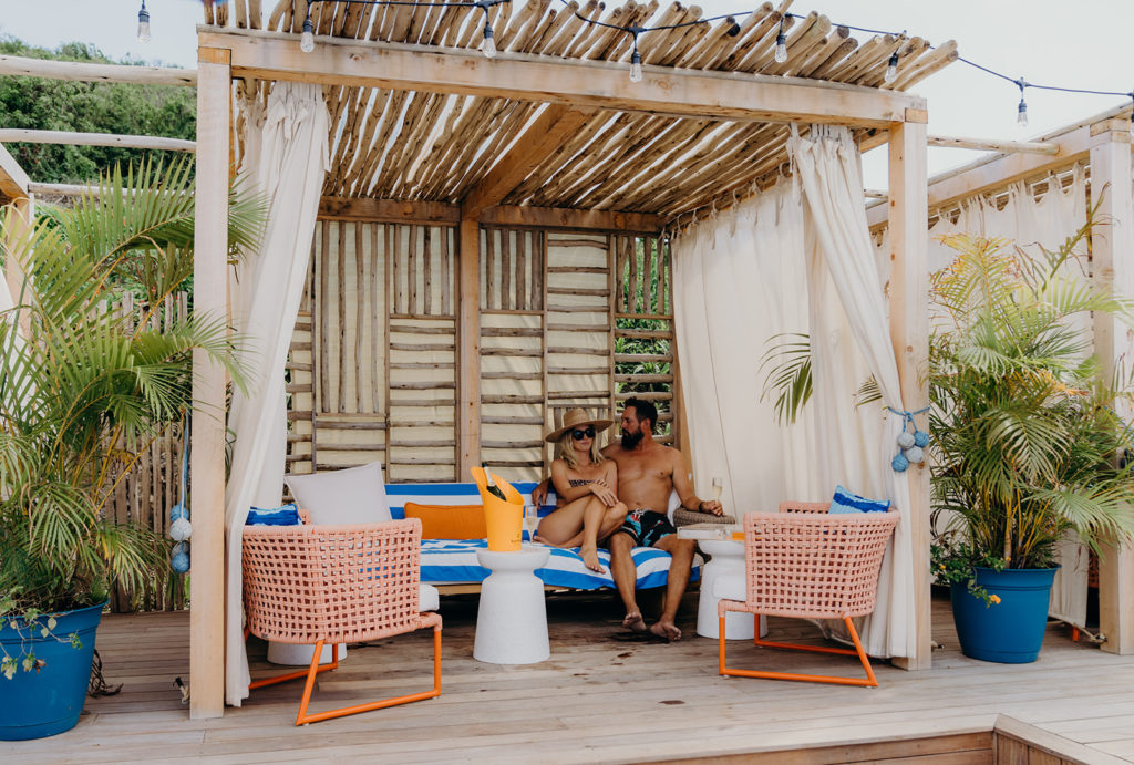 A couple sitting in a beach hut is one of many things to do in St. John