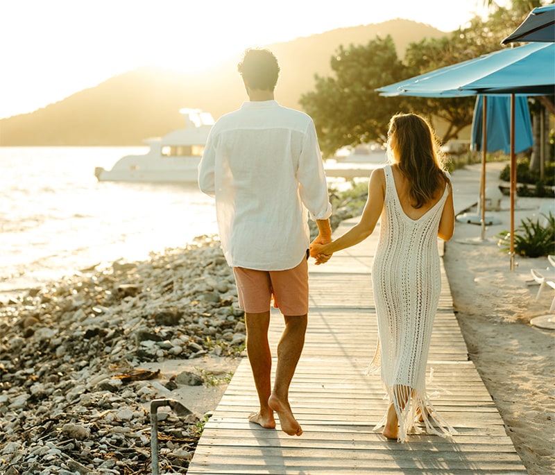 Woman and man holding hands near the water in Lovango St. John
