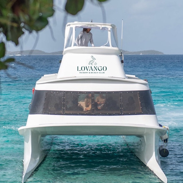 Lovango Resort & Beach Club ferry cruising through the turquoise waters of the Caribbean.