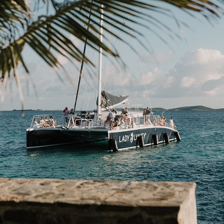 Guests aboard a sailing catamaran on the Caribbean waters near Lovango Island
