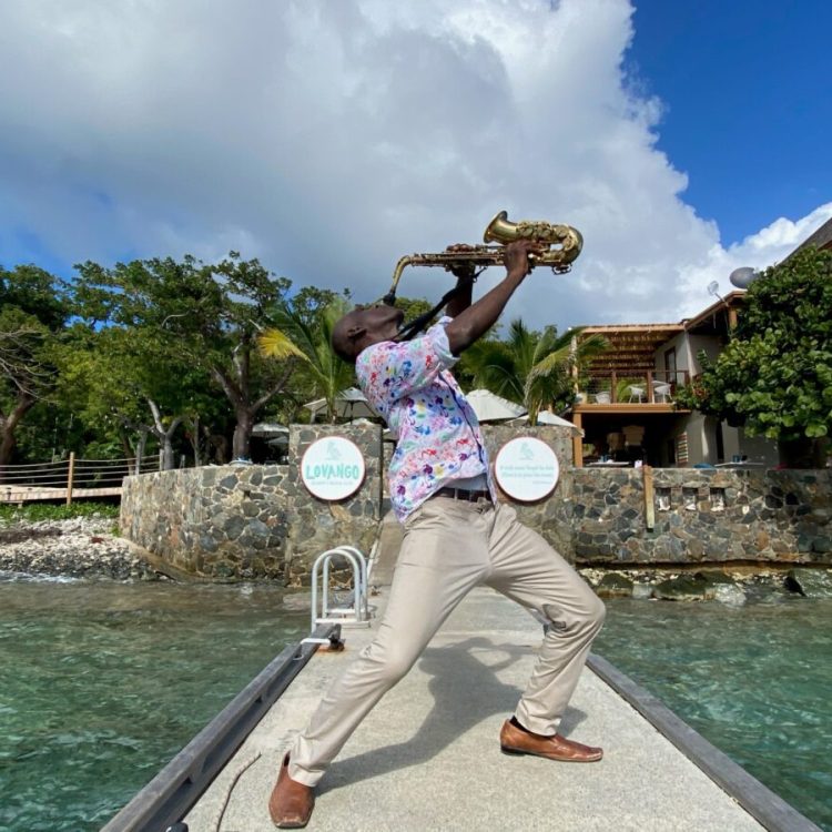 A man playing saxophone on the dock