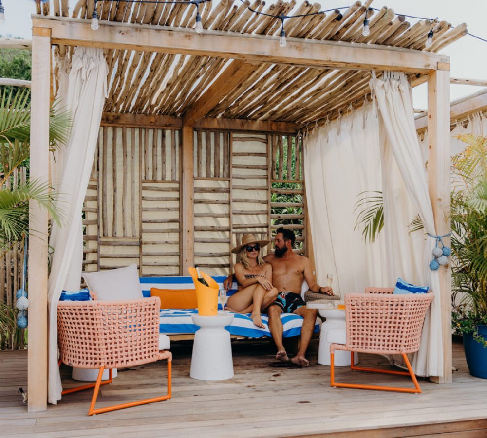A couple sitting in a beach hut is one of many things to do in St. John