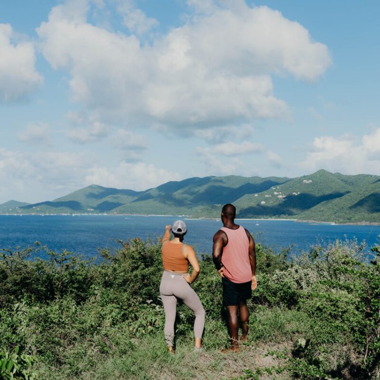 A man and woman looking out at the water