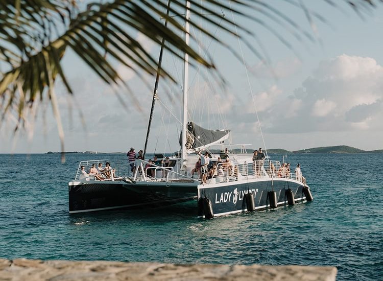 Lovango Bay Virgin Islands Destination, Man and Woman kissing behind a hat