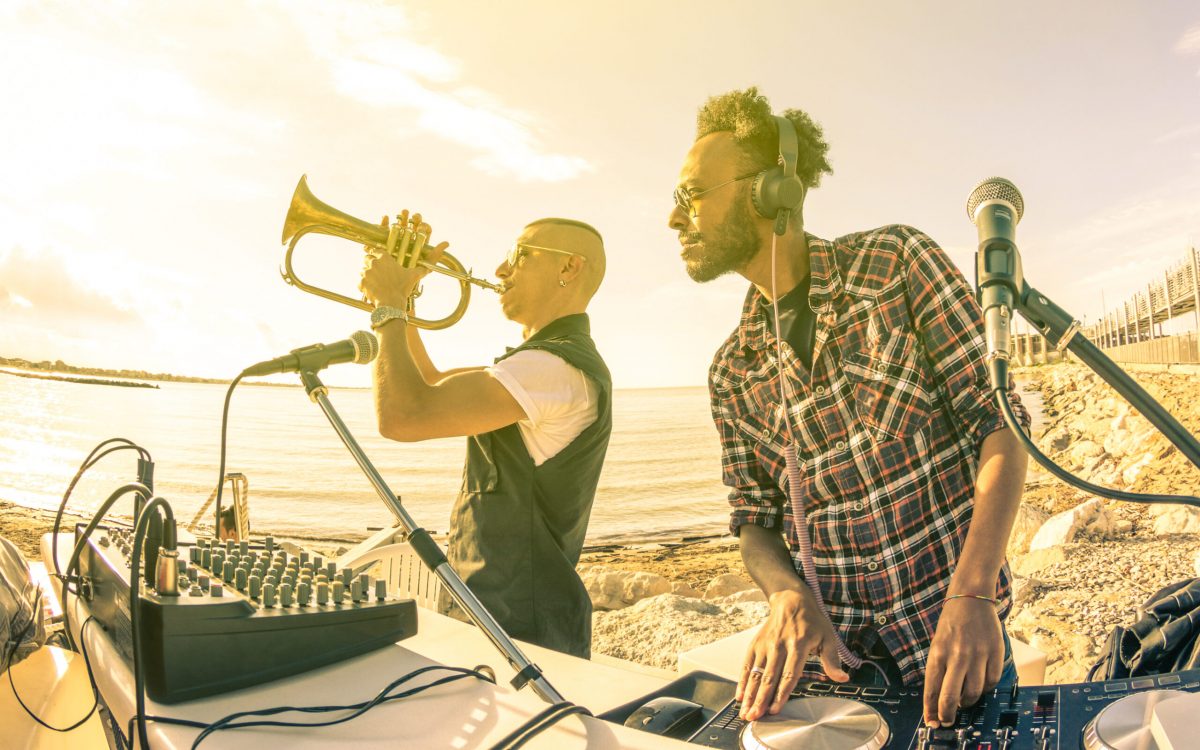 Dj,Playing,Summer,Hits,At,Sunset,Beach,Party,With,Trumpet